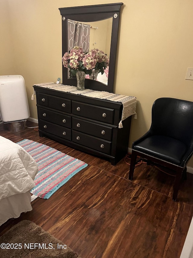 bedroom featuring dark wood-style flooring and baseboards