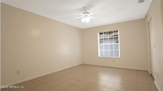 unfurnished room with a ceiling fan, a textured ceiling, and baseboards
