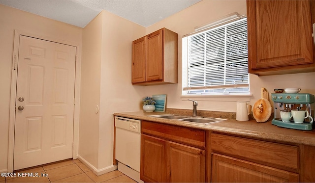 8878 Scott Woods Dr W, Jacksonville, FL 32208 - kitchen with a sink, brown cabinets, dishwasher, light countertops, and light tile patterned floors