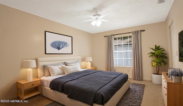 8878 Scott Woods Dr W, Jacksonville, FL 32208 - bedroom with a ceiling fan, a textured ceiling, light tile patterned floors, baseboards, and visible vents
