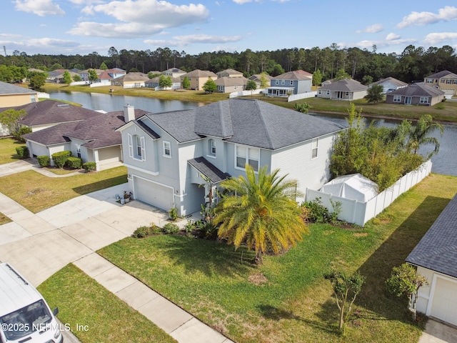 drone / aerial view with a water view and a residential view