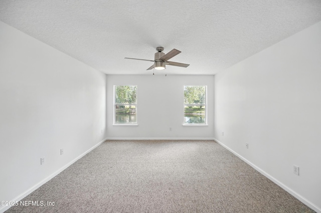 empty room with baseboards, a ceiling fan, and carpet