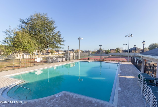 community pool featuring a residential view and fence