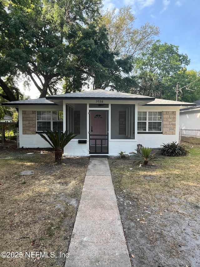 3128 Phyllis St, Jacksonville, FL 32205 - bungalow-style home featuring stone siding, concrete block siding, and fence