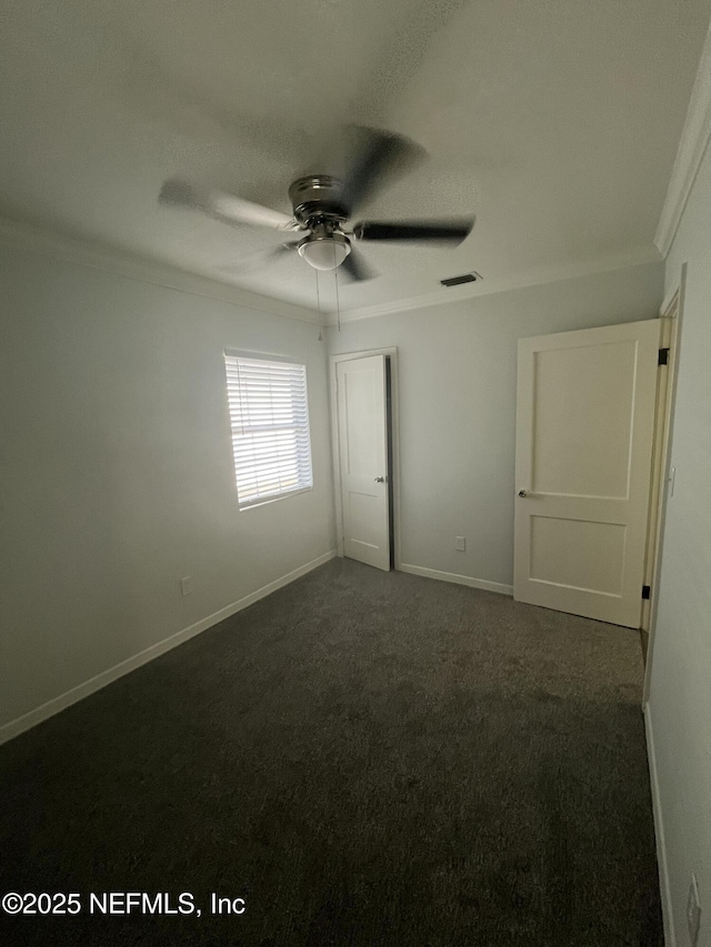 3128 Phyllis St, Jacksonville, FL 32205 - unfurnished bedroom featuring baseboards, visible vents, dark carpet, and crown molding