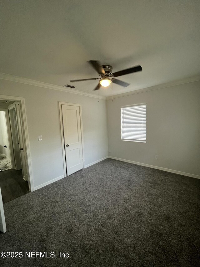 3128 Phyllis St, Jacksonville, FL 32205 - unfurnished bedroom with dark carpet, visible vents, ornamental molding, and baseboards