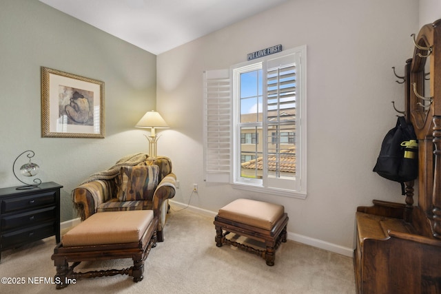 sitting room with baseboards and carpet floors