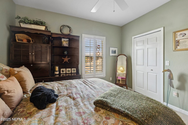 carpeted bedroom featuring ceiling fan and baseboards