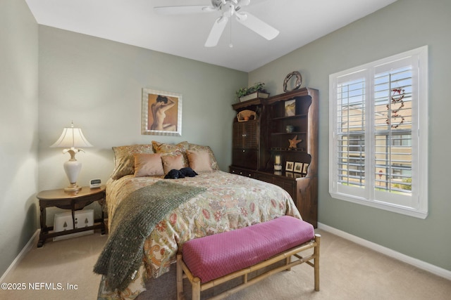carpeted bedroom featuring baseboards and ceiling fan