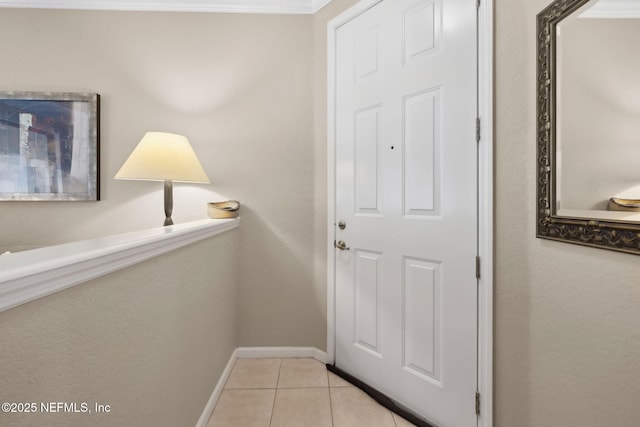 doorway to outside with baseboards and light tile patterned floors