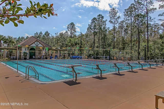 pool featuring a patio area and fence