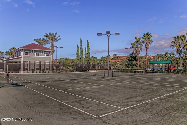 view of tennis court featuring fence