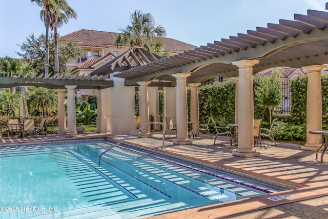 pool featuring outdoor dining space, a pergola, and a patio