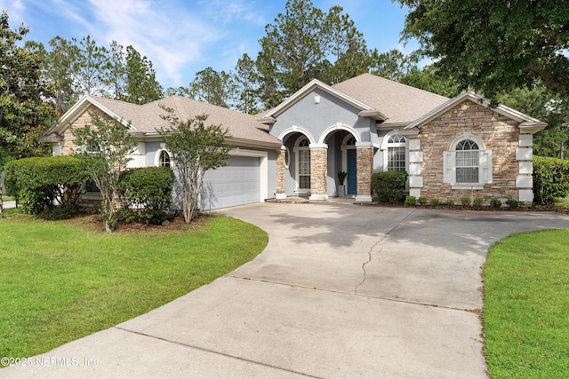 1071 Green Pine Cir, Orange Park, FL 32065 - view of front of property with concrete driveway, a garage, a front yard, and roof with shingles