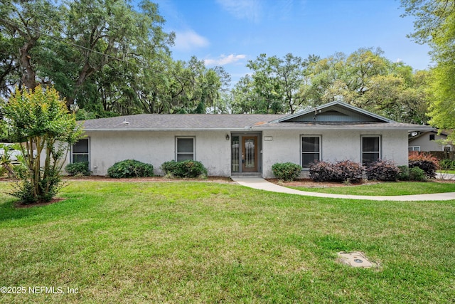 single story home featuring stucco siding and a front yard