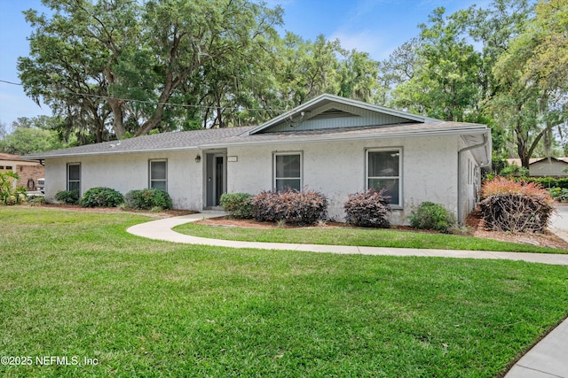 ranch-style home with stucco siding and a front yard