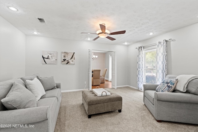 living room featuring carpet, ceiling fan, recessed lighting, and visible vents