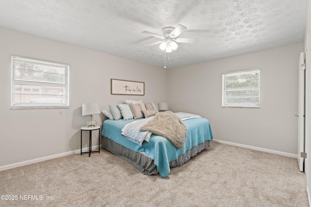 bedroom with baseboards, a ceiling fan, a textured ceiling, and carpet flooring