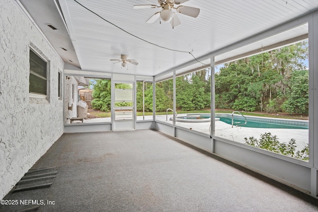 unfurnished sunroom with a hot tub, ceiling fan, and visible vents