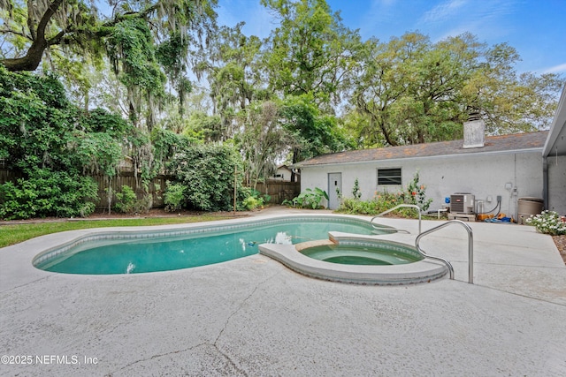 view of swimming pool with central AC, a fenced backyard, a pool with connected hot tub, and a patio area