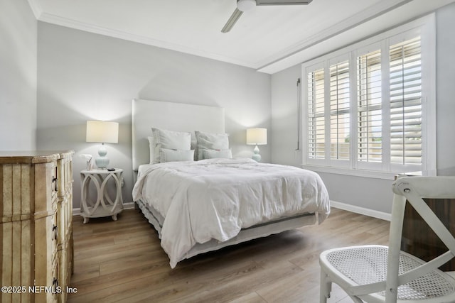 bedroom featuring crown molding, wood finished floors, baseboards, and ceiling fan