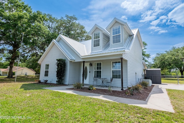 view of front of home with fence, a porch, and a front yard