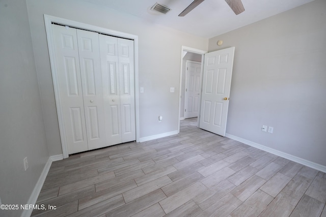 unfurnished bedroom with visible vents, baseboards, light wood-style flooring, and a closet