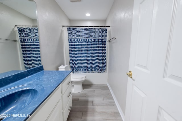 bathroom featuring recessed lighting, vanity, toilet, baseboards, and wood finish floors