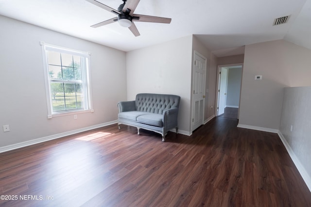 sitting room featuring ceiling fan, dark wood-type flooring, visible vents, vaulted ceiling, and baseboards