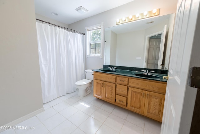 bathroom with toilet, double vanity, a sink, and visible vents