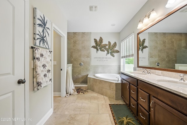bathroom with double vanity, walk in shower, a sink, and a bath