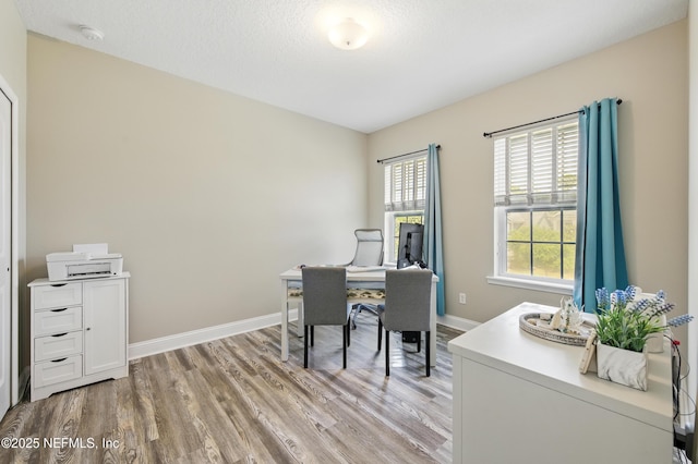 home office featuring baseboards and light wood-style flooring