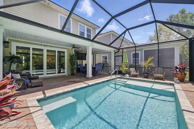 pool featuring glass enclosure, a patio, ceiling fan, and an outdoor living space