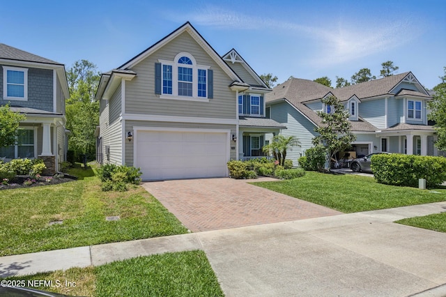 view of front of property with a garage, decorative driveway, and a front yard