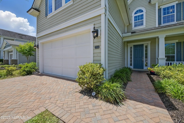exterior space with an attached garage and decorative driveway