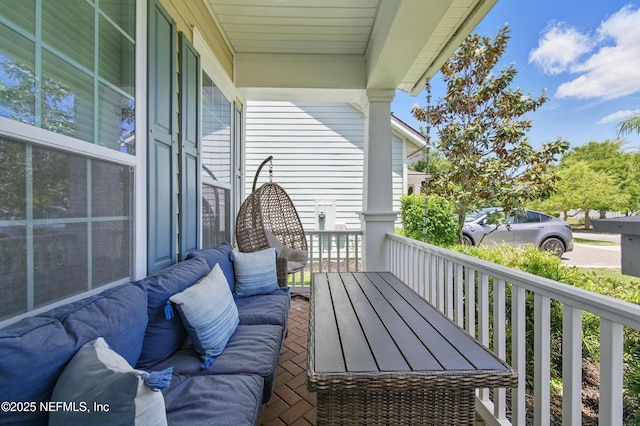 balcony featuring a porch and an outdoor living space