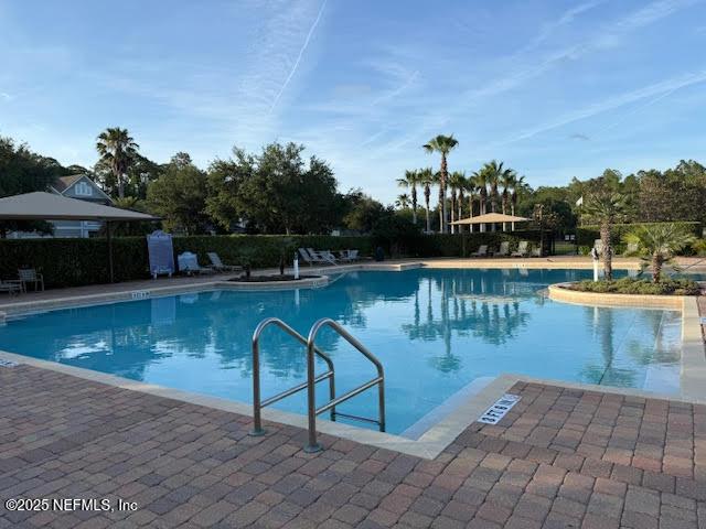 community pool with a patio area