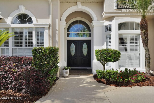 property entrance featuring stucco siding