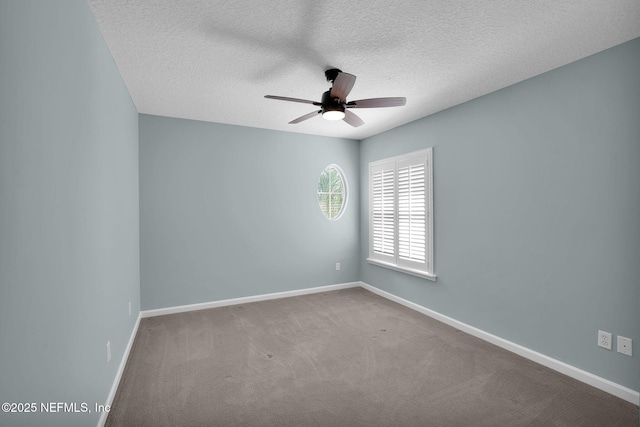 empty room featuring baseboards, a ceiling fan, carpet, and a textured ceiling