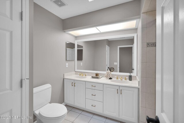 bathroom with visible vents, a sink, tile patterned flooring, and toilet