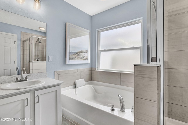 bathroom with vanity, a shower stall, and a bath