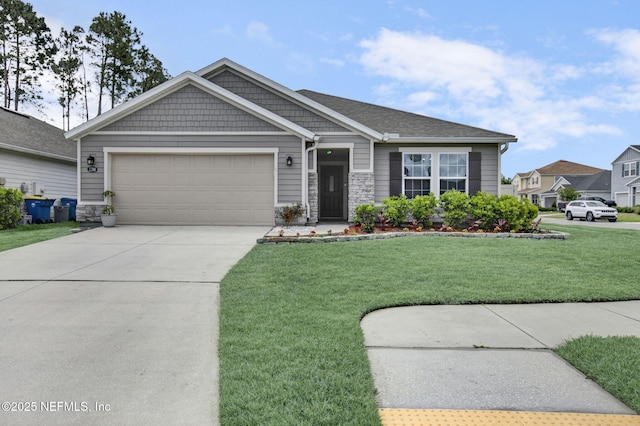 craftsman-style home with a garage, stone siding, a front yard, and concrete driveway