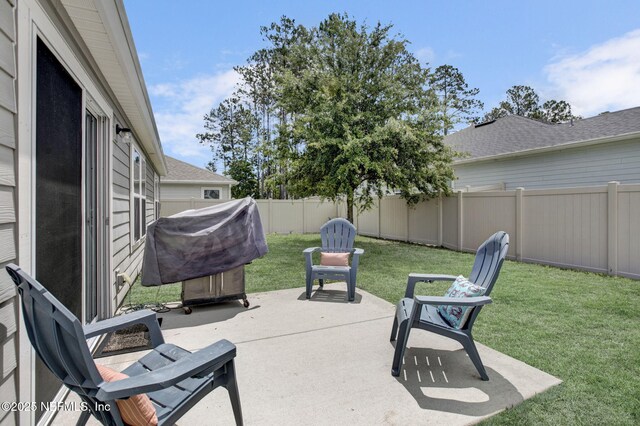 view of patio with grilling area and a fenced backyard