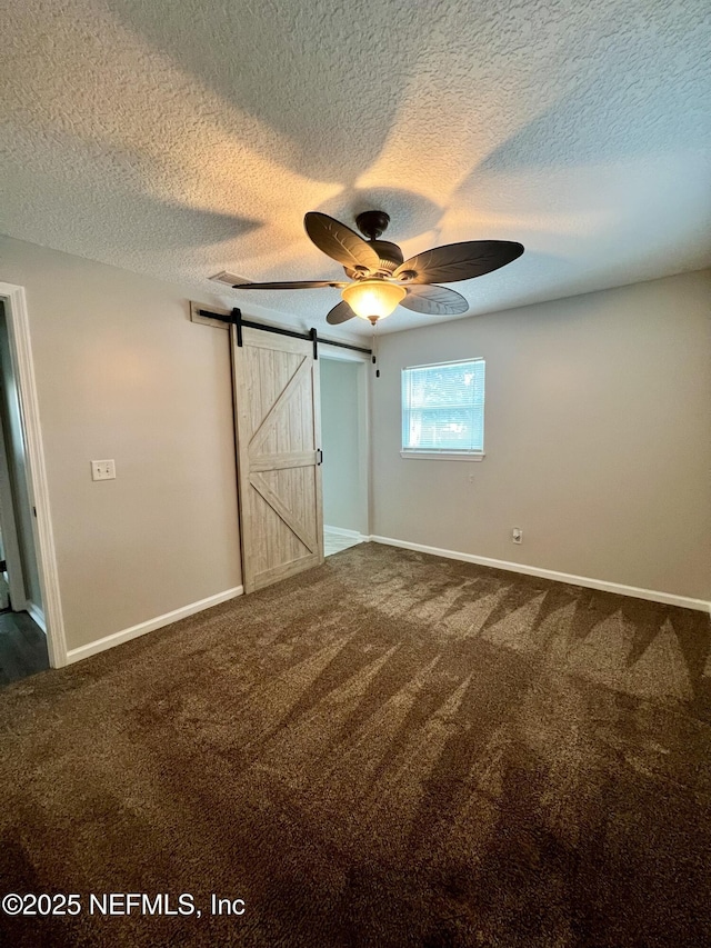 unfurnished bedroom featuring carpet floors and a textured ceiling