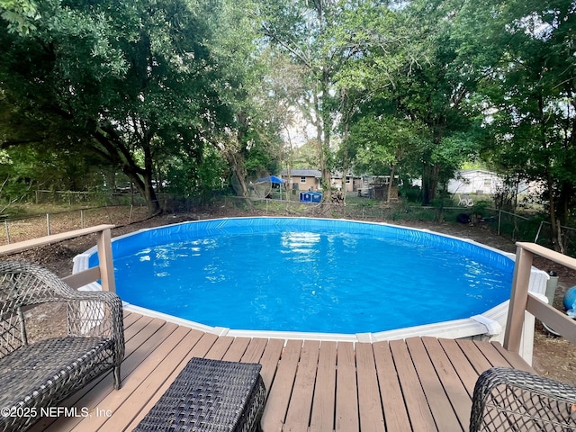 pool with a deck and fence