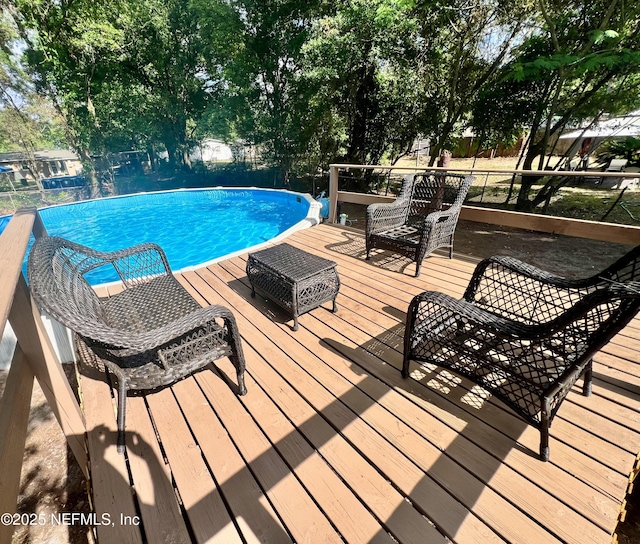 view of swimming pool with a fenced in pool, fence, and a wooden deck