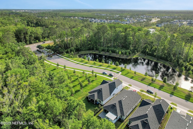 drone / aerial view with a water view and a forest view