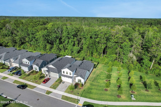 birds eye view of property featuring a wooded view