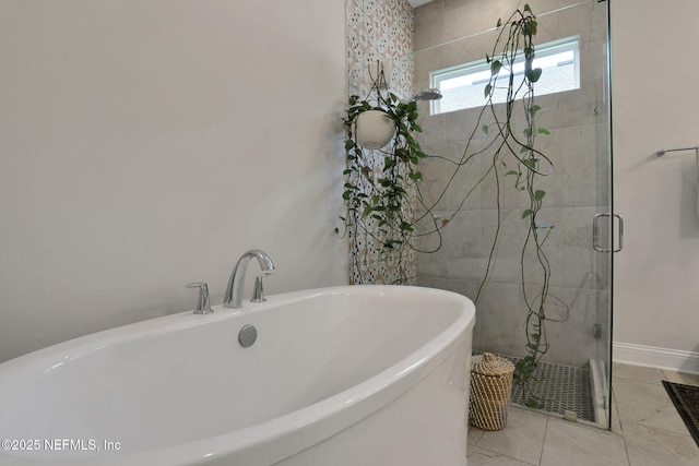 bathroom featuring a stall shower and a freestanding bath