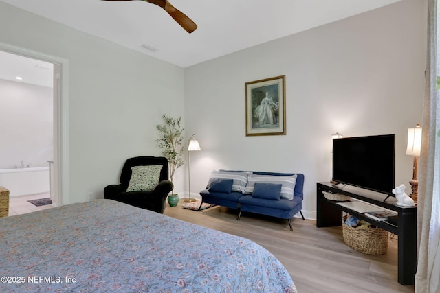 bedroom featuring a ceiling fan, visible vents, wood finished floors, and ensuite bathroom